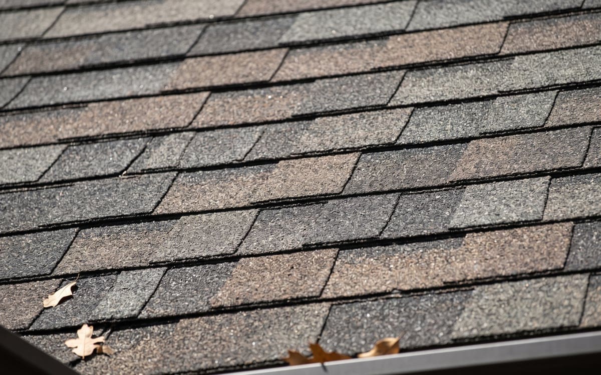Close view of laminated architectural shingles with their dimensional shadow lines.
